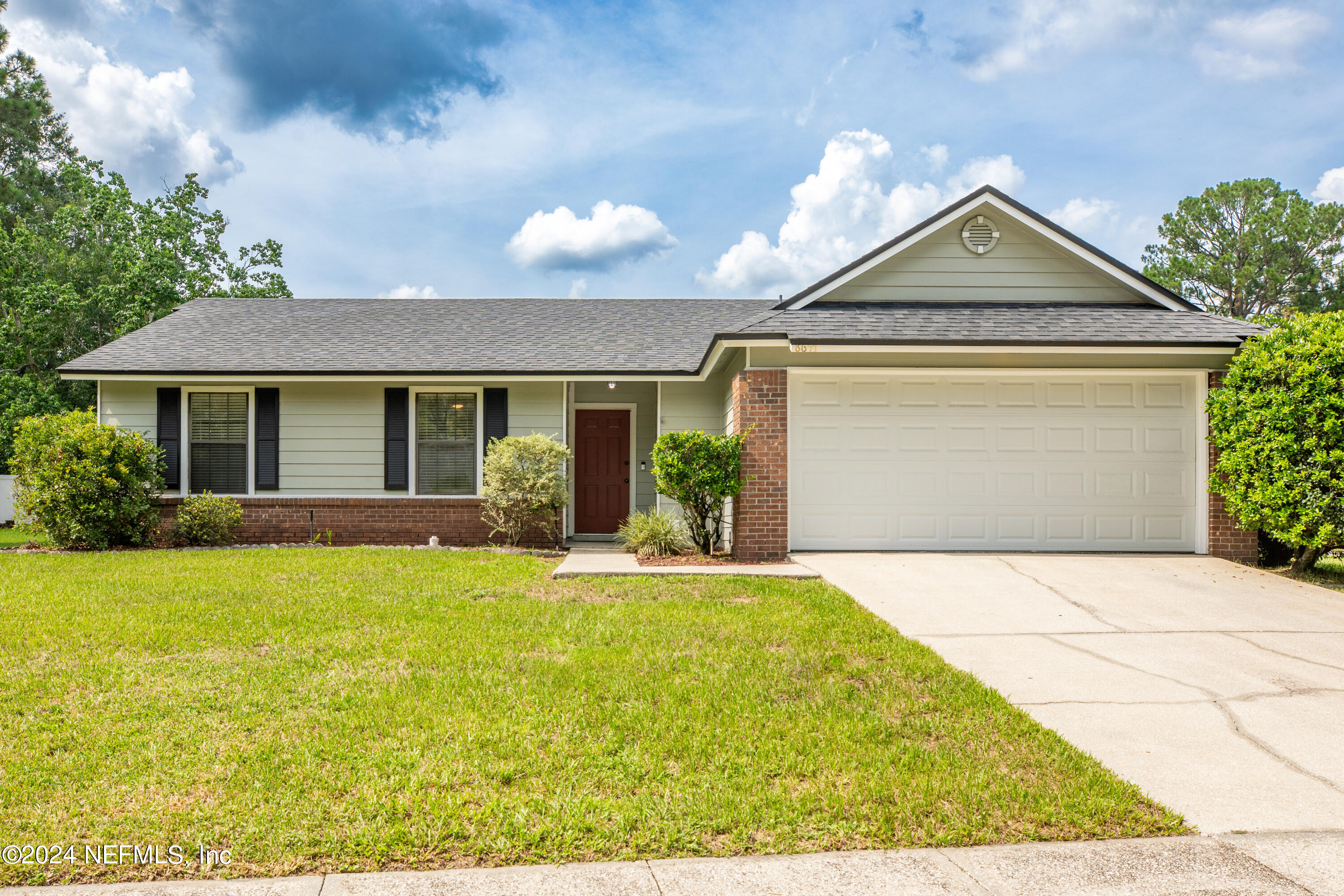 8691 Hammond Forest Drive Jacksonville, FL 32221 - Photo 1 of 28 a front view of a house with a yard and garage