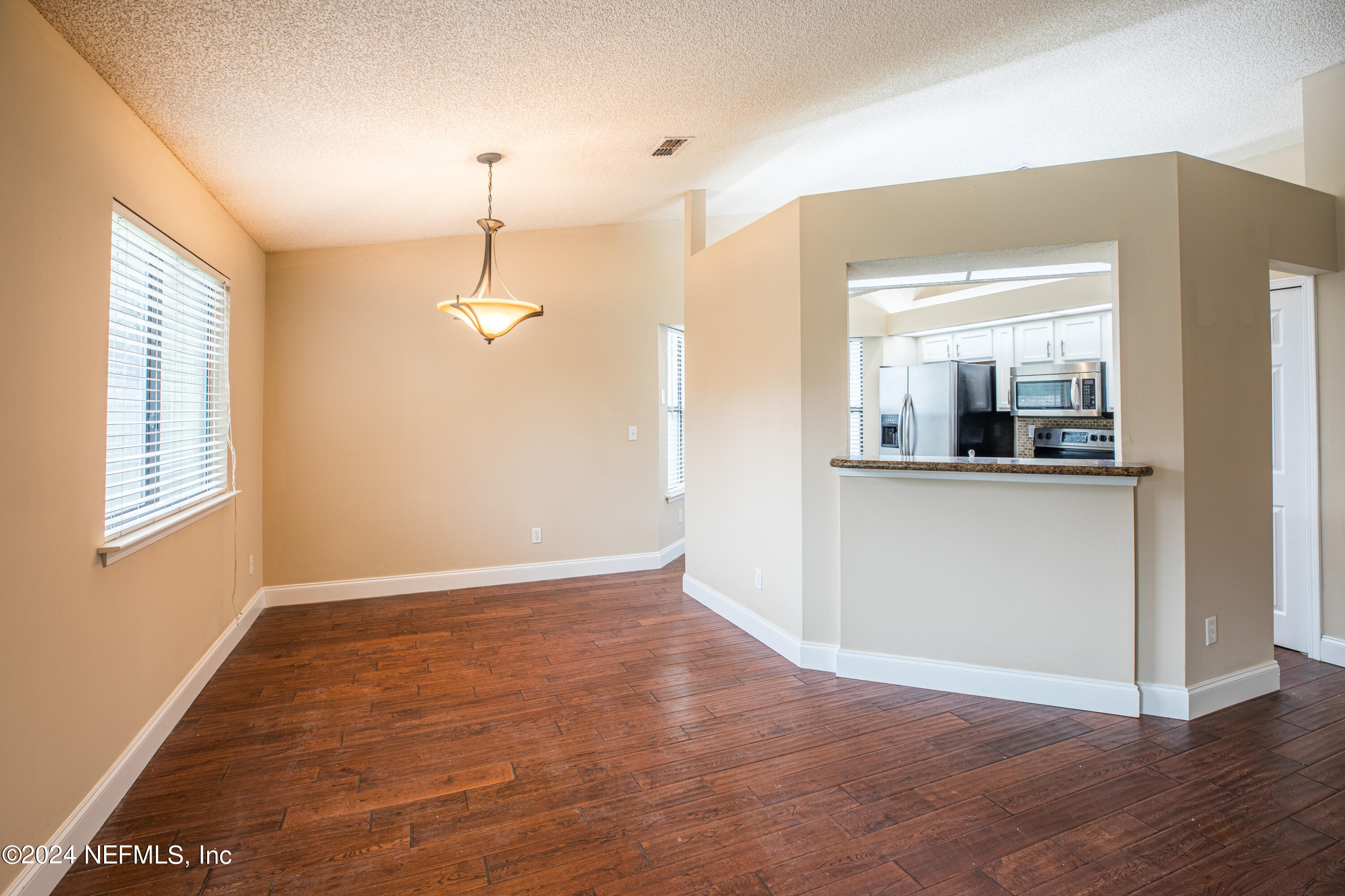 8691 Hammond Forest Drive Jacksonville, FL 32221 - Photo 12 of 28 a view of a room with wooden floor and windows