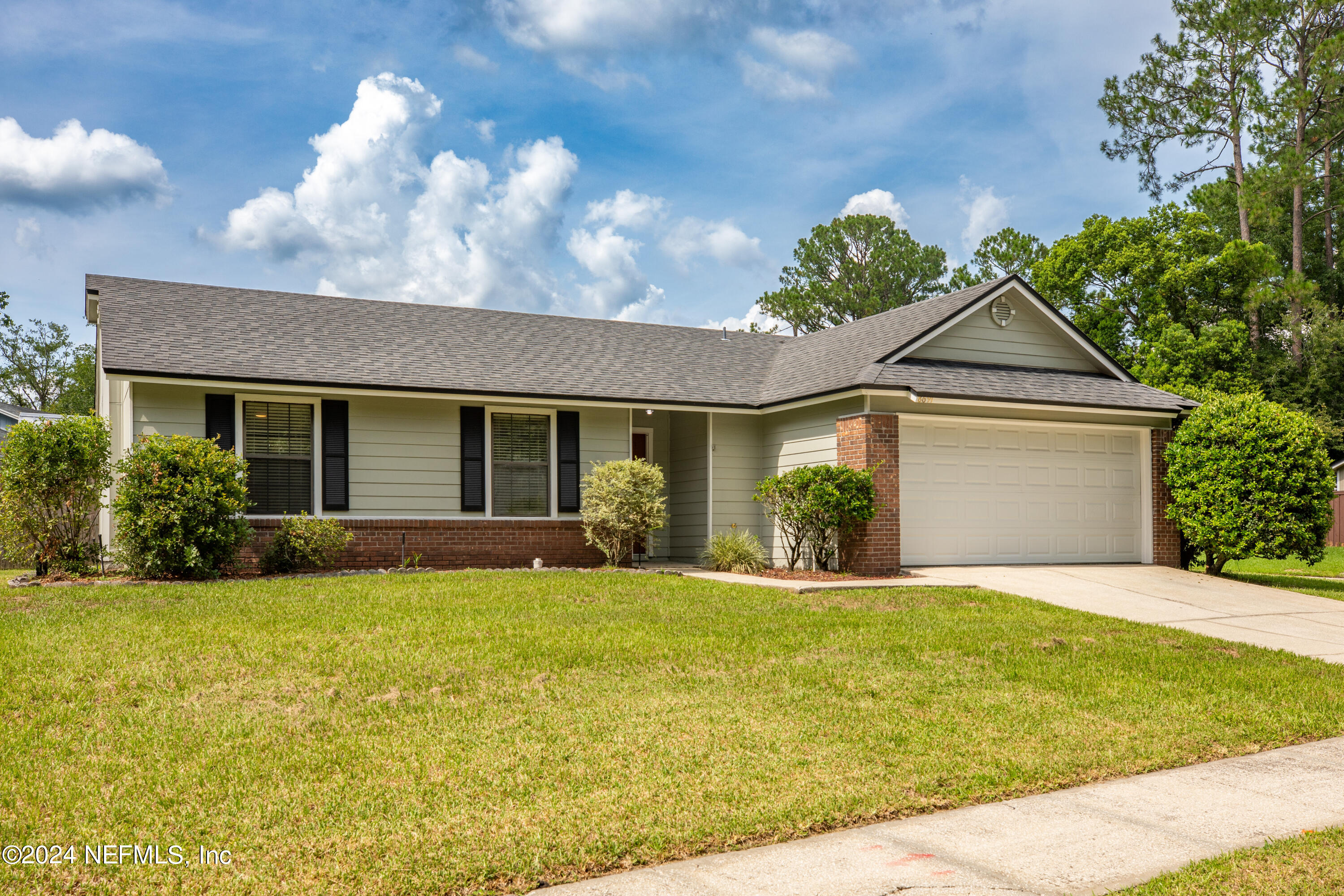 8691 Hammond Forest Drive Jacksonville, FL 32221 - Photo 3 of 28 a front view of a house with a yard and garage