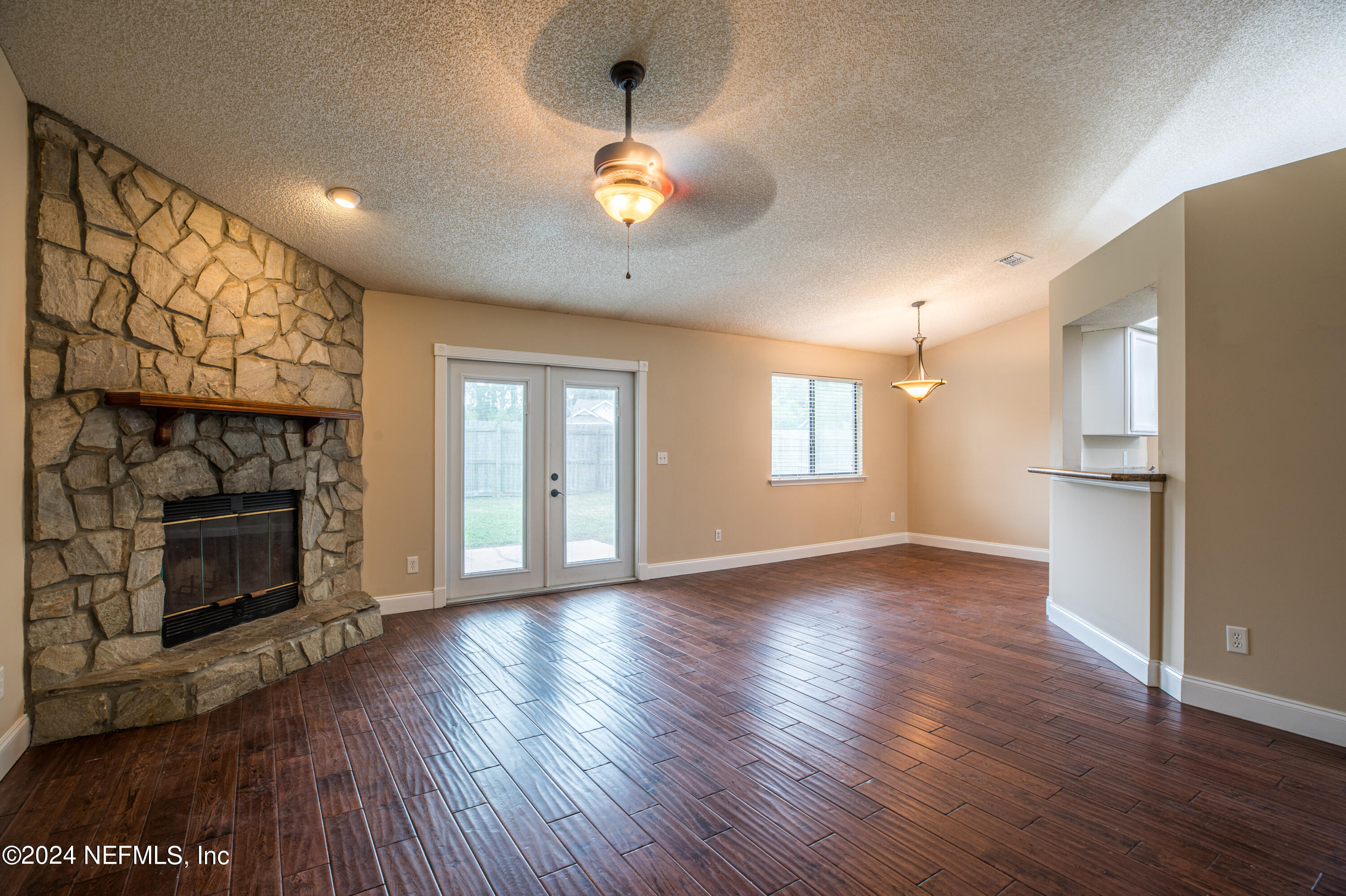 8691 Hammond Forest Drive Jacksonville, FL 32221 - Photo 8 of 28 a view of an empty room with wooden floor fireplace and a window