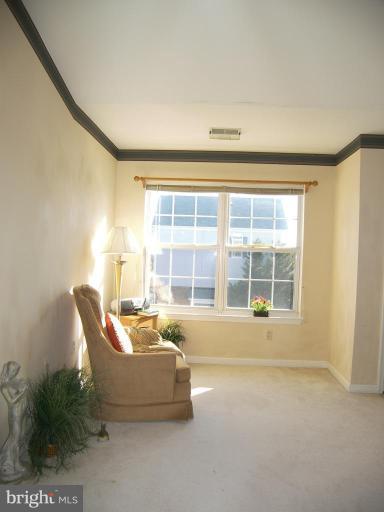 673 Constellation Square Southeast, Unit J Leesburg, VA 20175 - Photo 11 of 25 a living room with furniture and a window