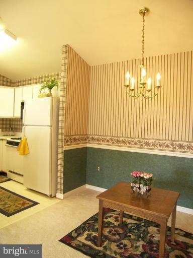 673 Constellation Square Southeast, Unit J Leesburg, VA 20175 - Photo 15 of 25 a kitchen with a refrigerator and a stove