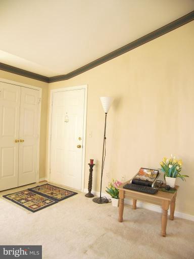673 Constellation Square Southeast, Unit J Leesburg, VA 20175 - Photo 16 of 25 a living room with a table and chairs