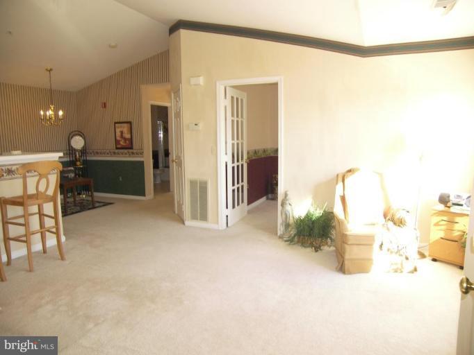 673 Constellation Square Southeast, Unit J Leesburg, VA 20175 - Photo 8 of 25 a view of a room with furniture and a mirror