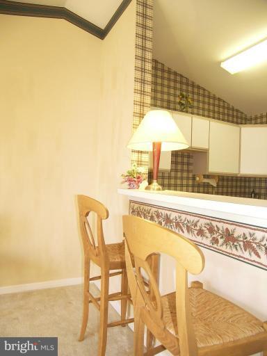 673 Constellation Square Southeast, Unit J Leesburg, VA 20175 - Photo 9 of 25 a view of a dining room with furniture and a chandelier