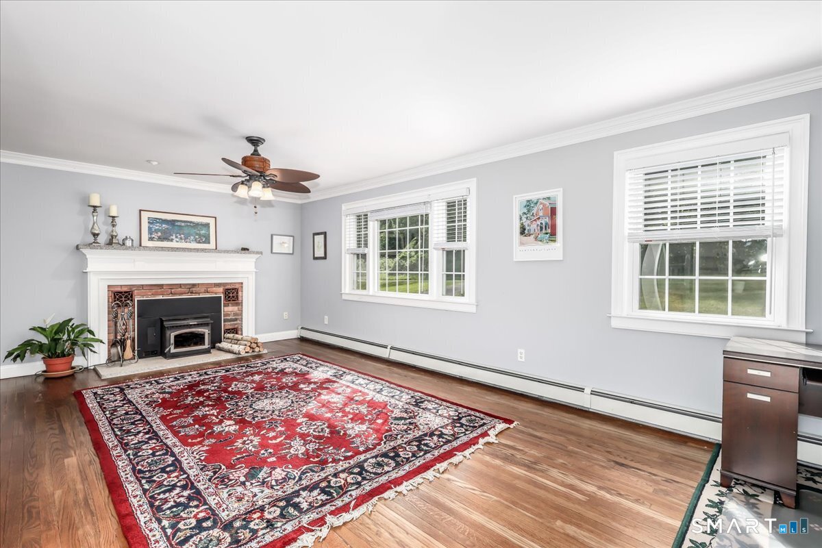 19 Botsford Hill Road Newtown, CT 06470 - Photo 17 of 40 a living room with a rug and a fireplace