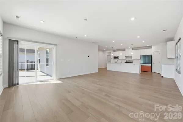 a view of kitchen with kitchen island and stainless steel appliances