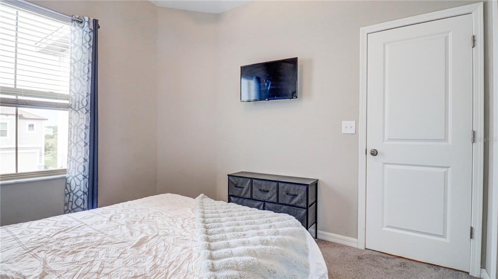 31632 Blue Passing Loop Wesley Chapel, FL 33545 - Photo 35 of 48 a bedroom with a bed and a window