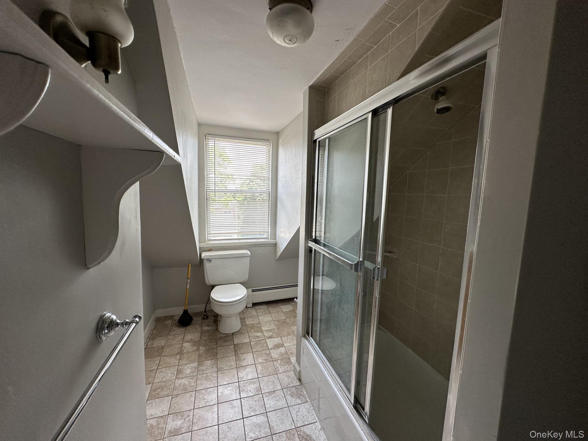 10 Prospect Street Nyack, NY 10960 - Photo 6 of 7 Bathroom featuring tiled shower / bath combo, baseboard heating, and light tile patterned flooring