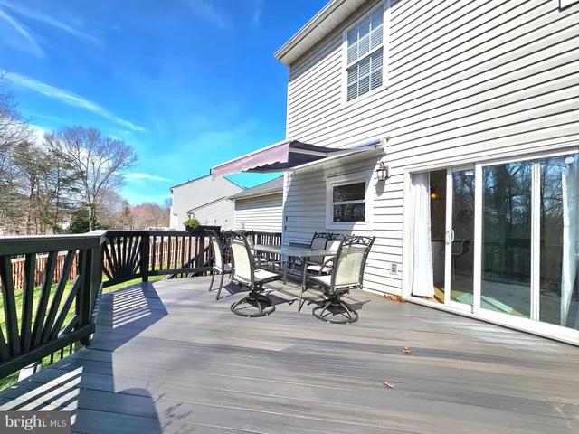 a view of a patio with table and chairs and wooden floor