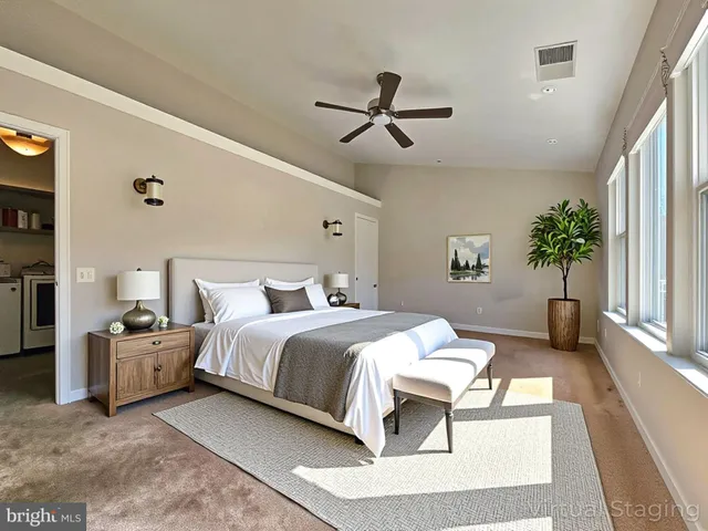 a bedroom with a large bed and windows