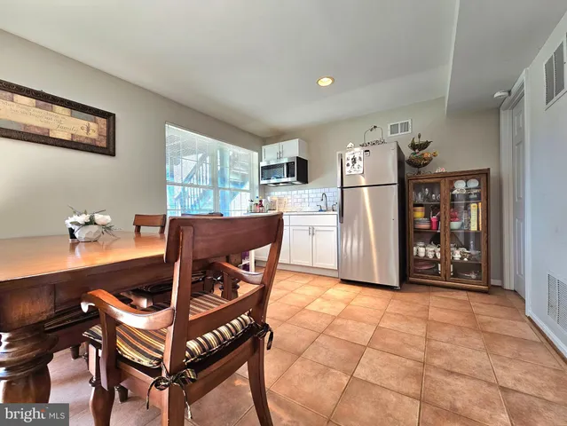 a living room with furniture a flat screen tv and a table