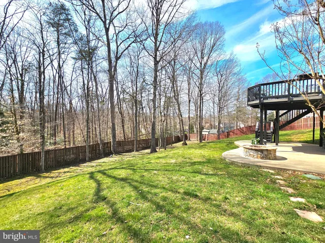 a swimming pool with outdoor seating and yard
