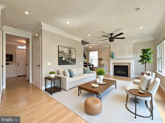 a living room with furniture a fireplace and a chandelier