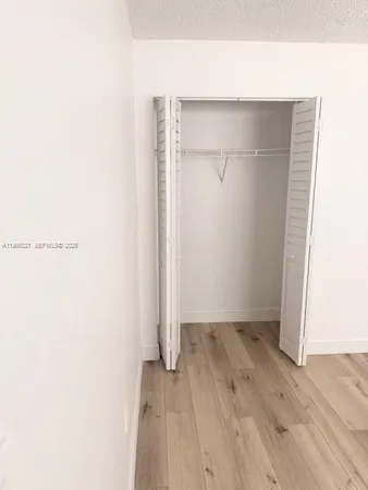 a bathroom with a granite countertop sink a toilet and a shower