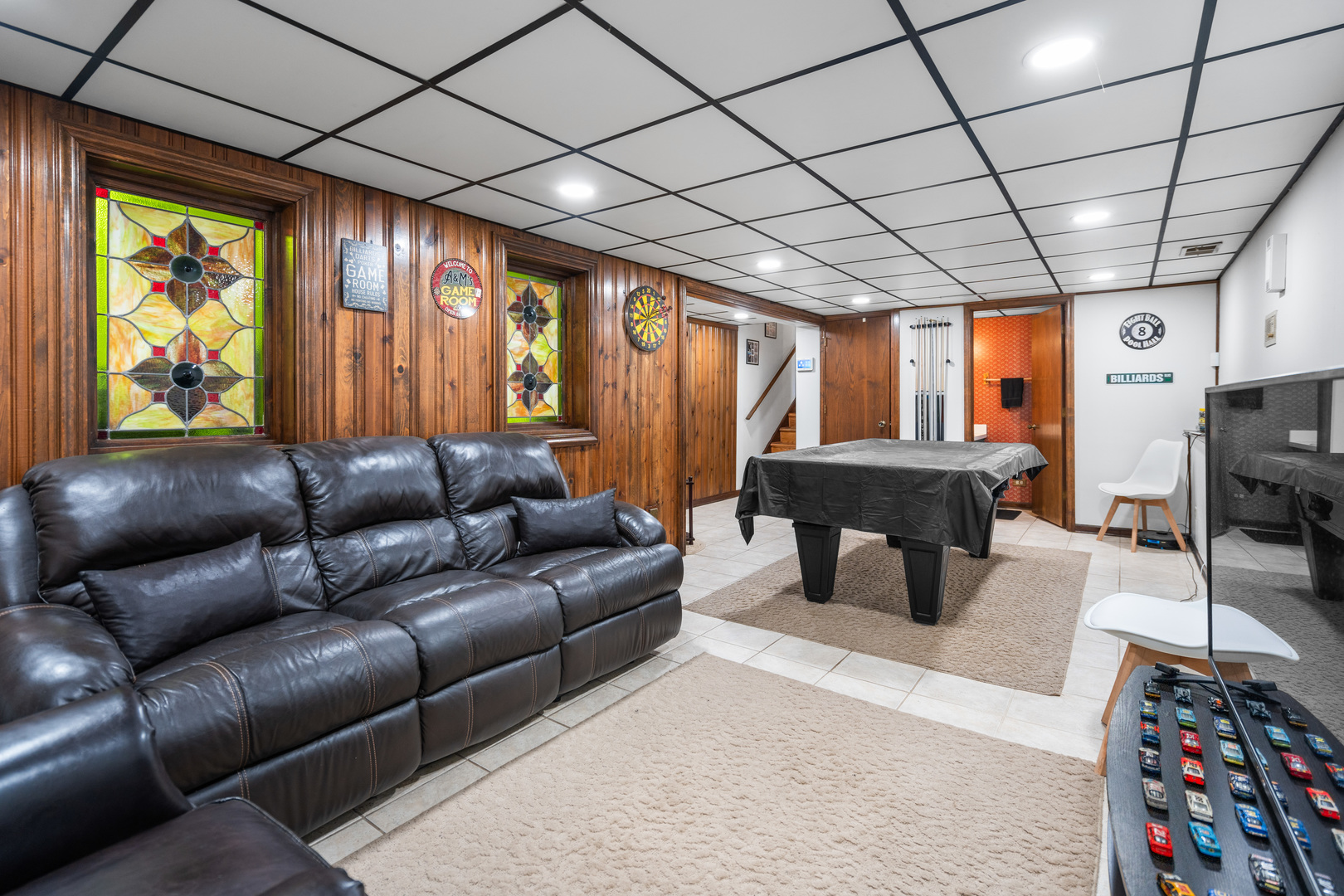 3479 Ronald Road Crete, IL 60417 - Photo 24 of 38 a living room with furniture a flat screen tv and a floor to ceiling window