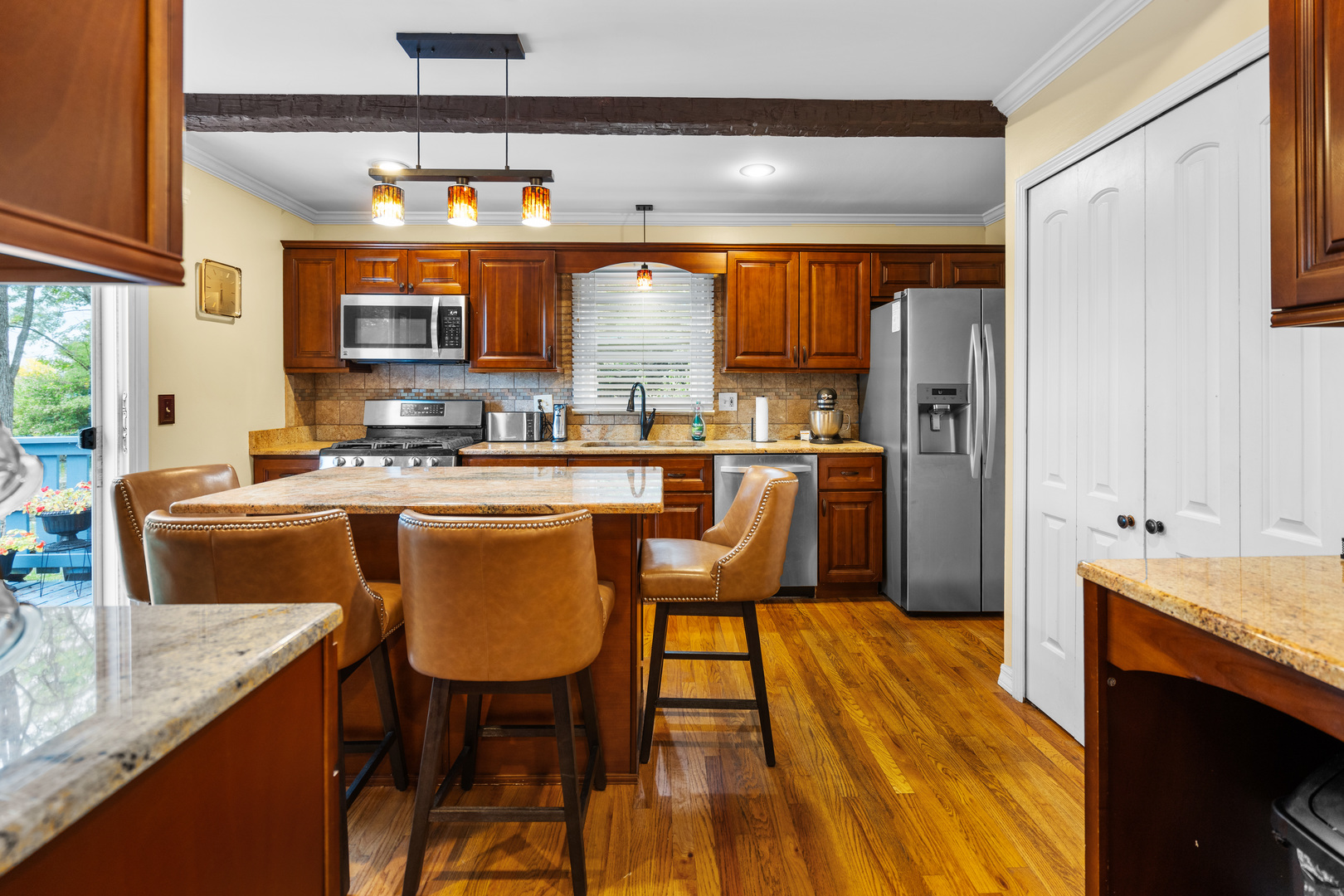 3479 Ronald Road Crete, IL 60417 - Photo 9 of 38 a kitchen with stainless steel appliances granite countertop a sink a stove and a refrigerator