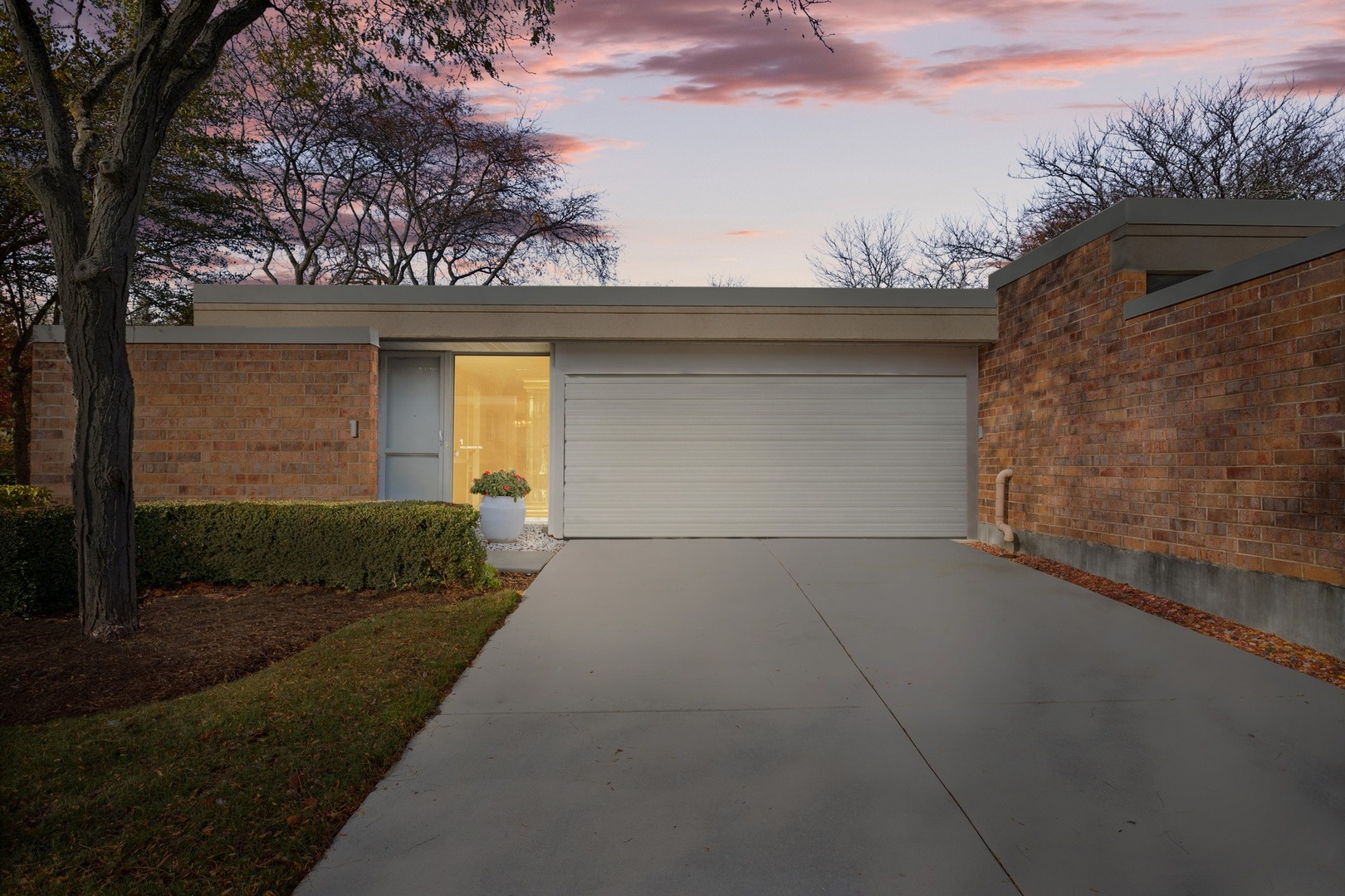 1 Wellington Road Northbrook, IL 60062 - Photo 2 of 27 a front view of a house with a yard and garage