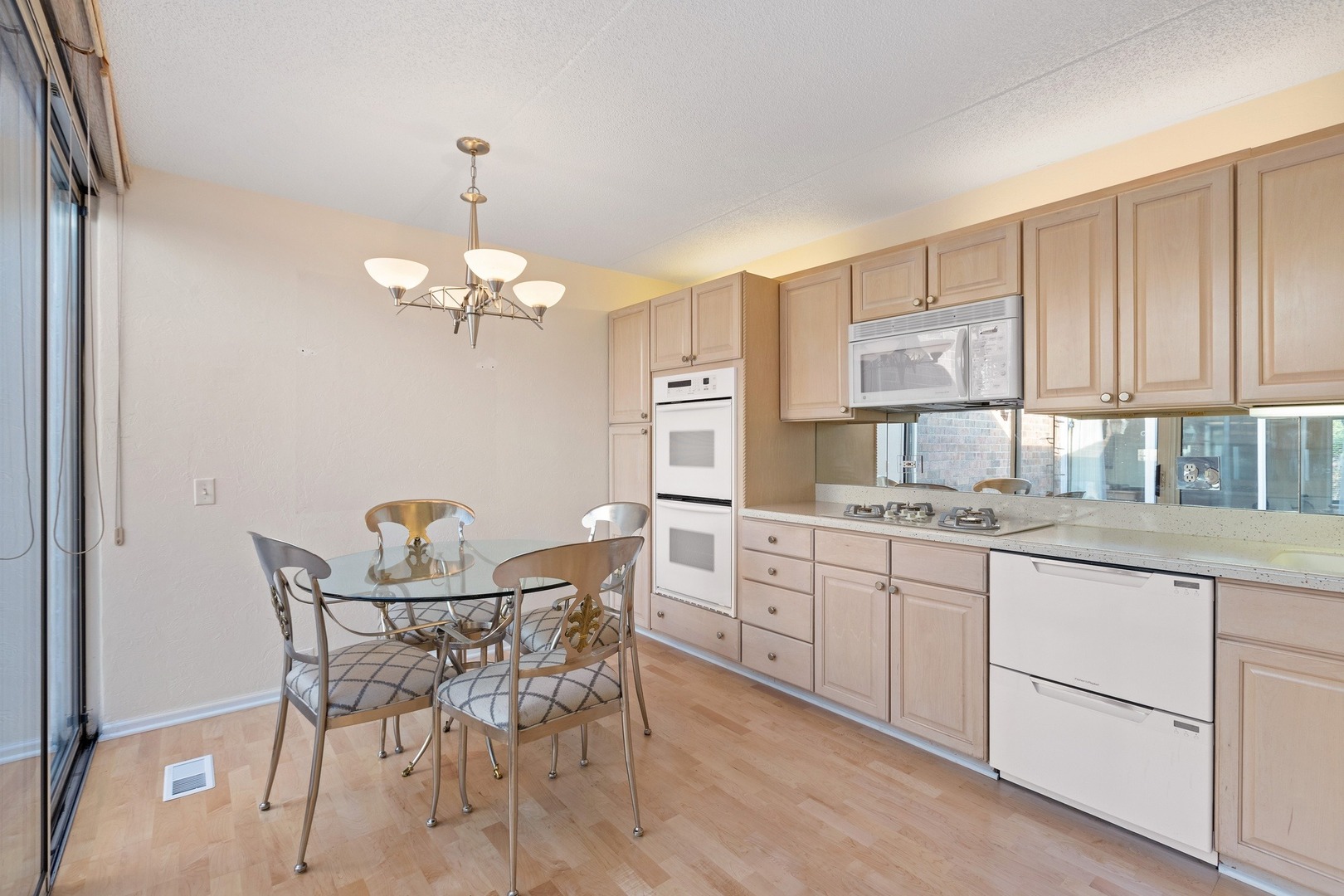 1 Wellington Road Northbrook, IL 60062 - Photo 15 of 27 a dining room filled chandelier and kitchen view