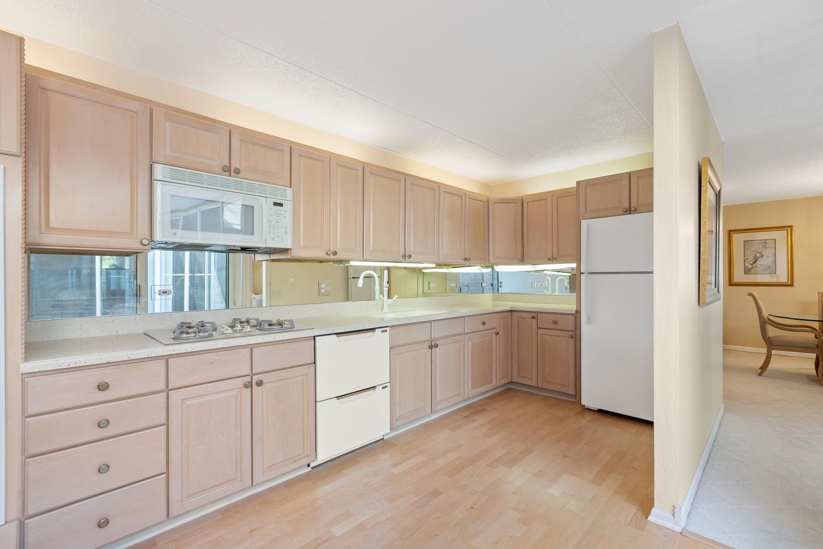 1 Wellington Road Northbrook, IL 60062 - Photo 16 of 27 a kitchen with white cabinets and white appliances