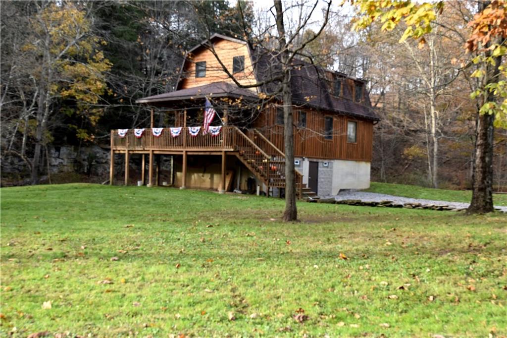 a view of a house with a backyard