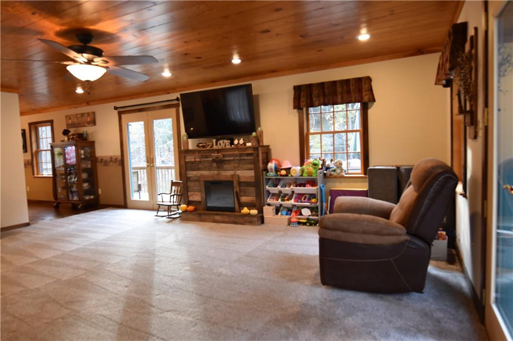 1242 Stitts Run Road Vandergrift, PA 15690 - Photo 9 of 23 a living room with furniture a flat screen tv and a fireplace