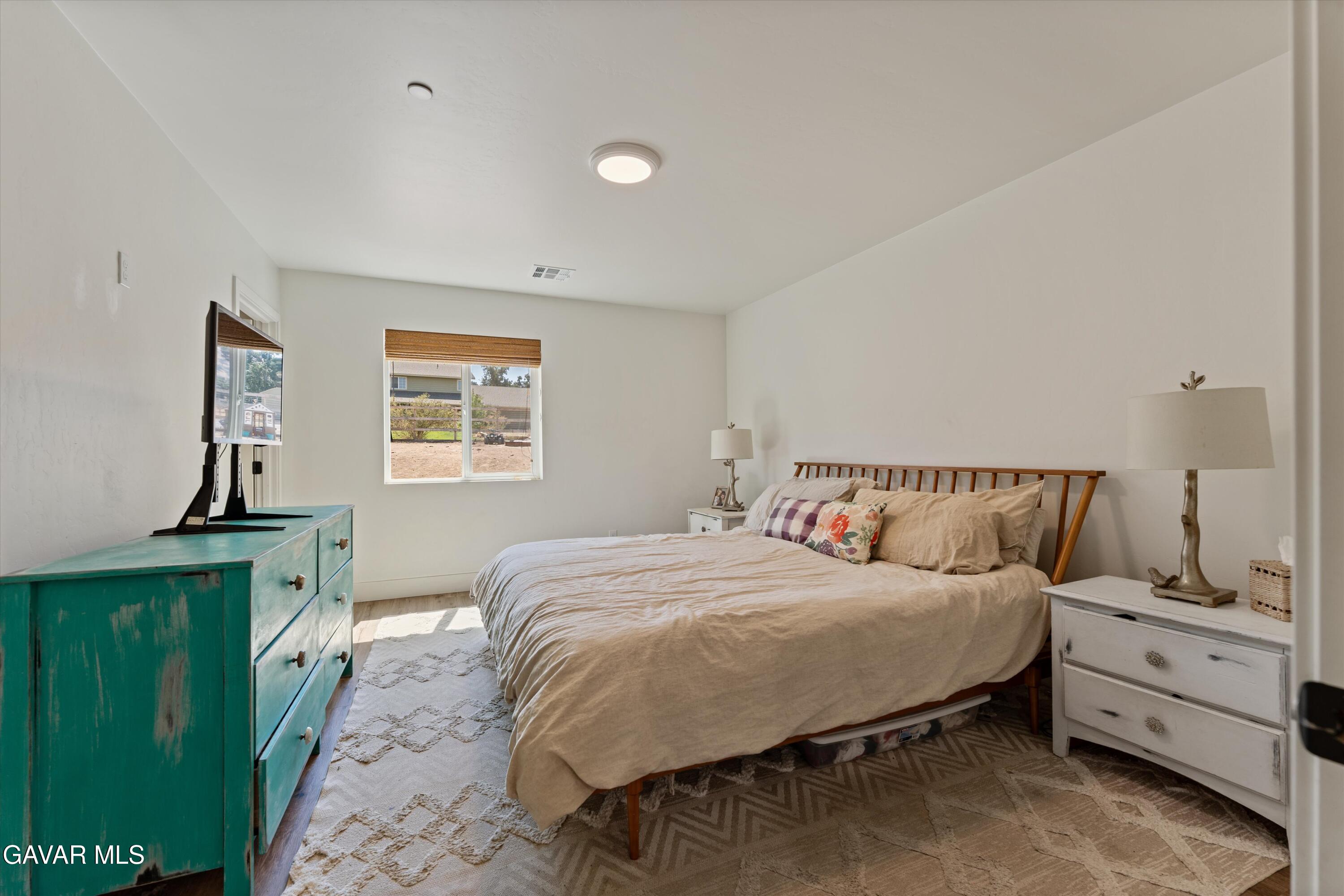 28060 Preakness Drive Tehachapi, CA 93561 - Photo 13 of 26 a bedroom with a bed and a window