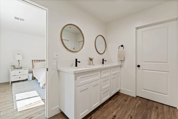 a bathroom with a double vanity sink and a mirror