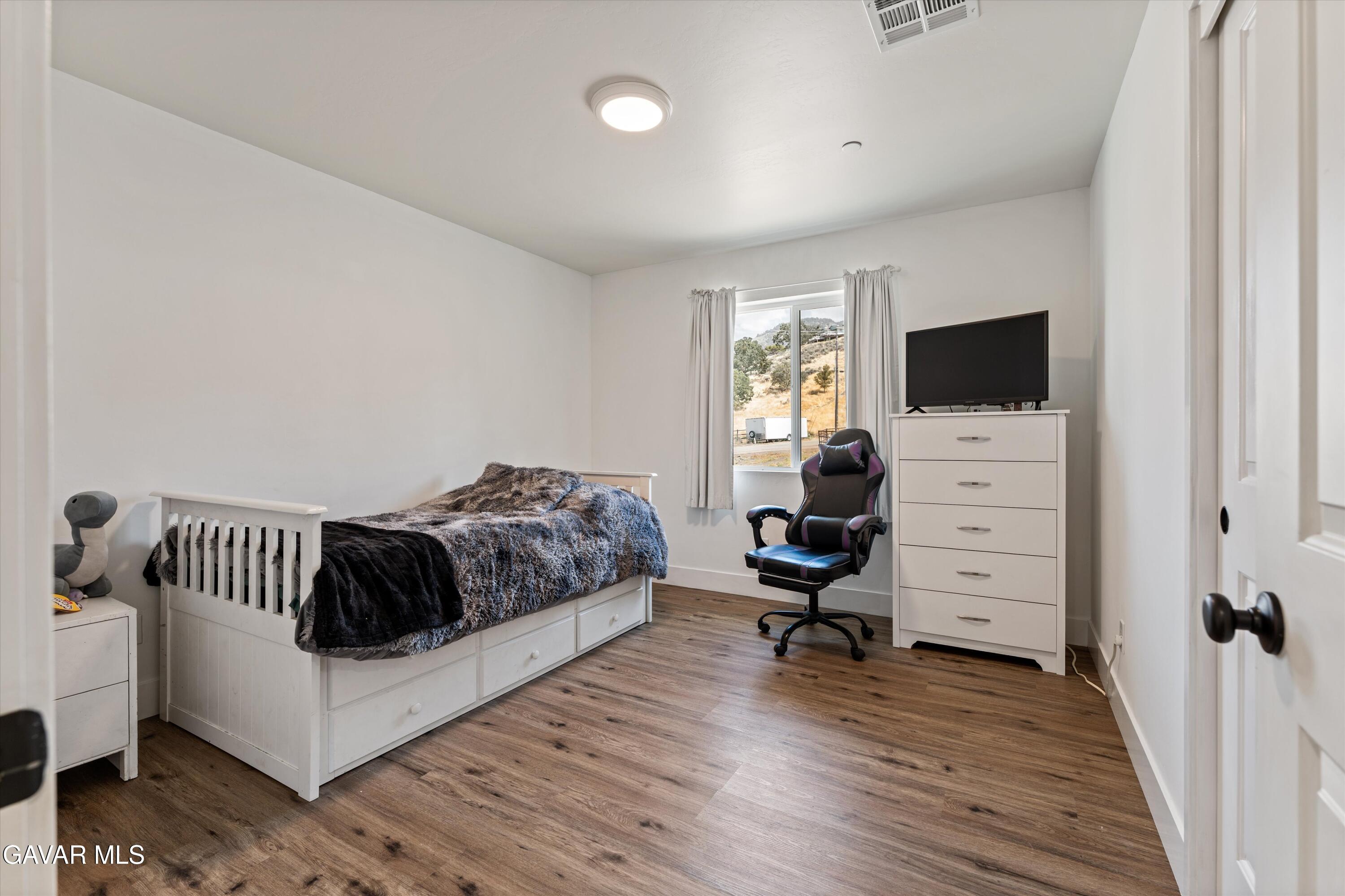 28060 Preakness Drive Tehachapi, CA 93561 - Photo 16 of 26 a living room with furniture and a flat screen tv