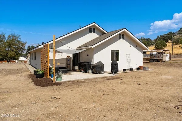 a view of a white house with a outdoor space