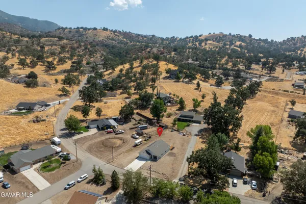 an aerial view of residential houses with outdoor space