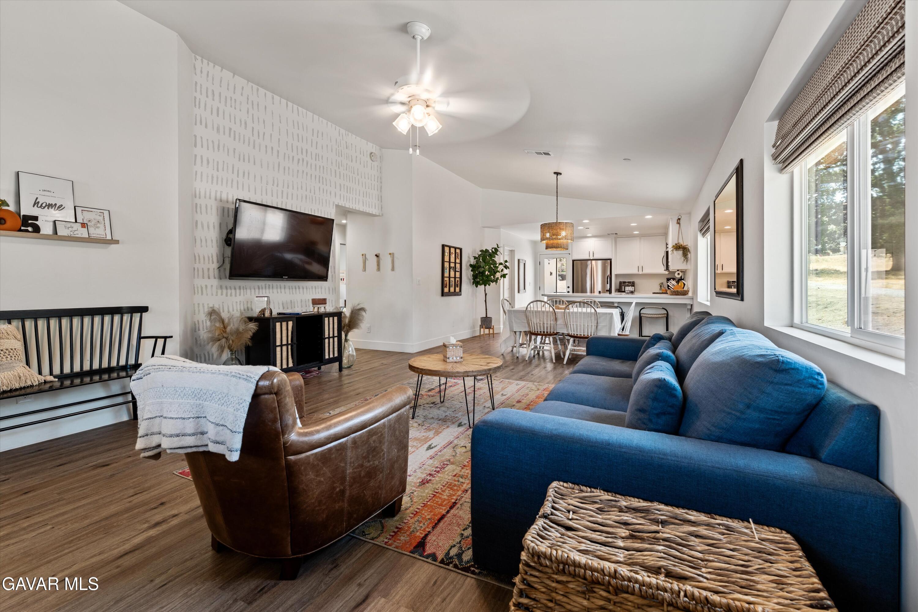 28060 Preakness Drive Tehachapi, CA 93561 - Photo 9 of 26 a living room with furniture a flat screen tv and kitchen view