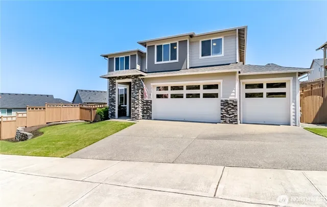 a front view of a house with a yard and garage