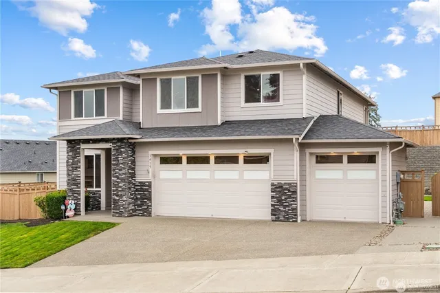 a front view of a house with a yard and garage