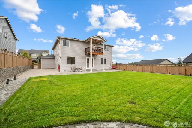 a view of a house with a backyard porch and sitting area