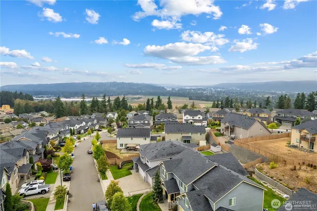 an aerial view of a house with a garden and trees