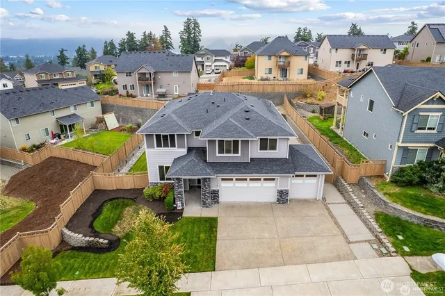 an aerial view of a house with a yard