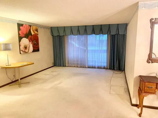 a view of an empty room with wooden wall and painting on the wall