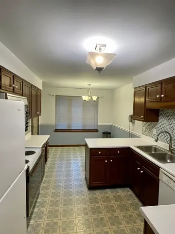 a large bathroom with a large tub and sink