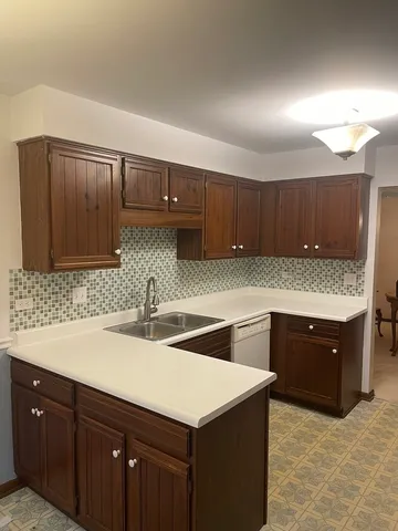 a kitchen with granite countertop a sink and a stove