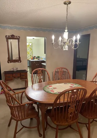 a view of a dining room with furniture and chandelier
