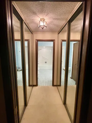 a view of a hallway with windows and stairs