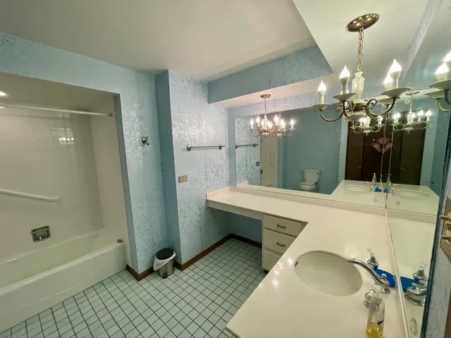 a bathroom with a sink a mirror and a bathtub