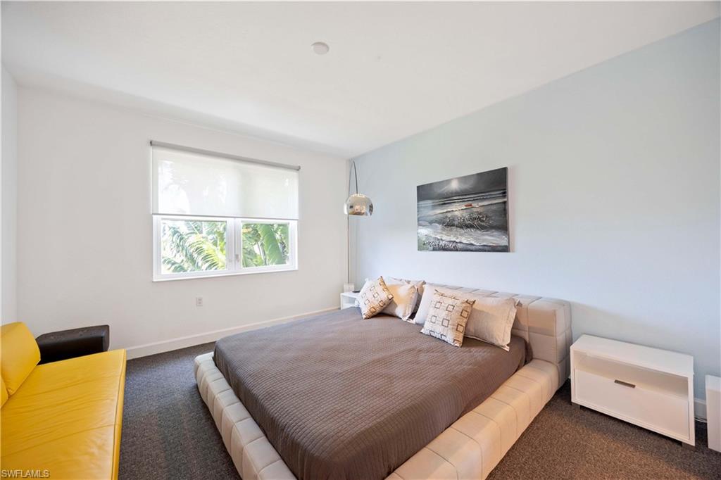 4685 Hawks Nest Way, Unit J201 Naples, FL 34114 - Photo 13 of 24 a bedroom with a bed and a couch