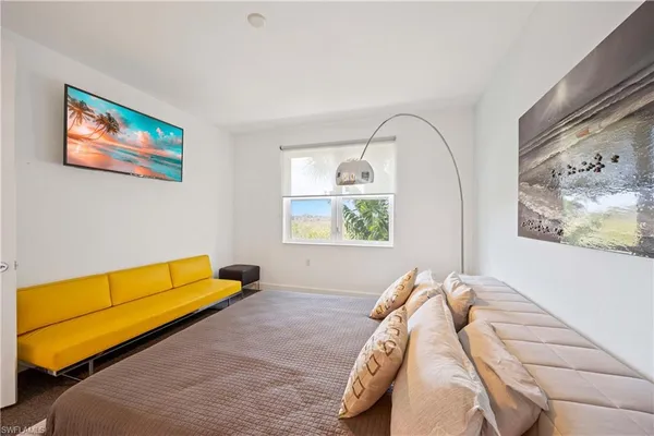a bed sitting in a bedroom next to a window