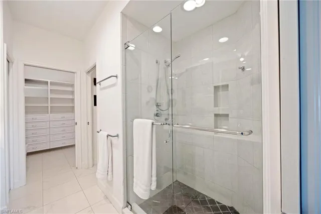 a bathroom with a shower and a glass door