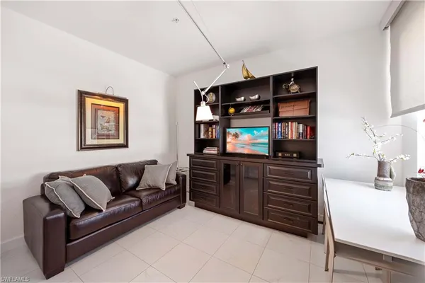 a living room with furniture and painting on the wall