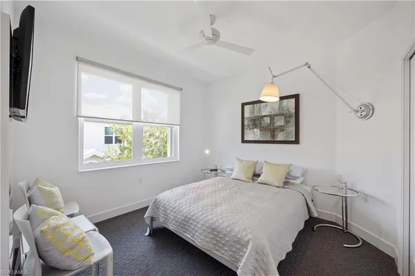 a bedroom with a bed and chair