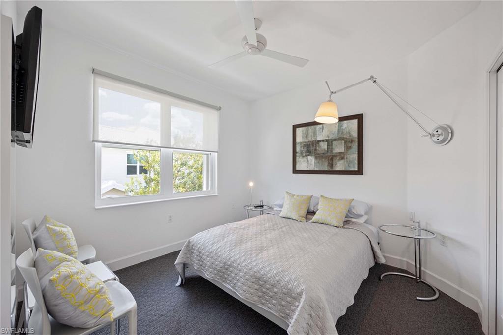 4685 Hawks Nest Way, Unit J201 Naples, FL 34114 - Photo 19 of 24 a bedroom with a bed and chair