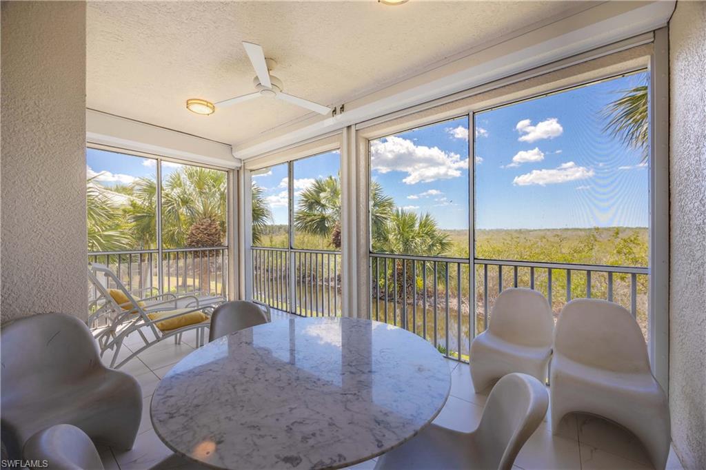 4685 Hawks Nest Way, Unit J201 Naples, FL 34114 - Photo 22 of 24 a balcony with furniture and a potted plant